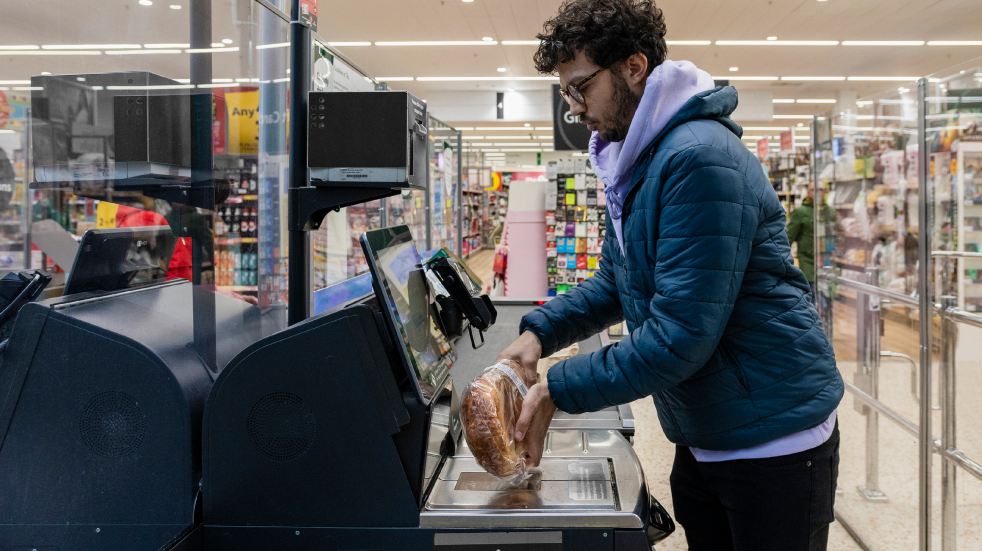 man at self checkout